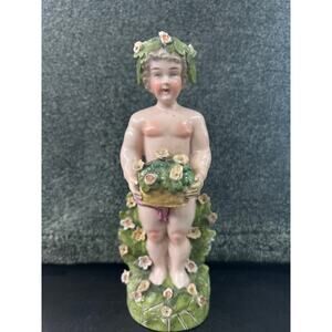 Porcelain Putto Sculpture carrying a floral basket c1780